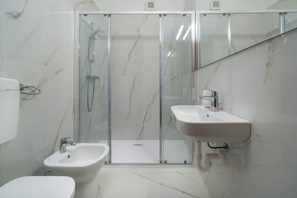 Family Room, Multiple Beds | Bathroom | Shower, free toiletries, bidet, towels