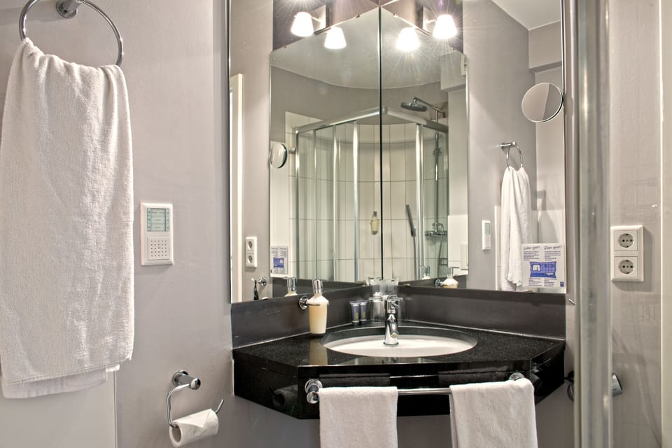 Shower, hair dryer, slippers, towels