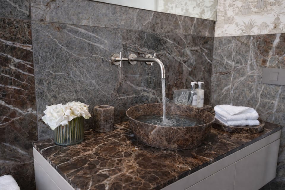 Suite | Bathroom | Designer toiletries, hair dryer, slippers, towels