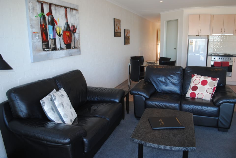 1 Bedroom Apartment | Living area | Flat-screen TV