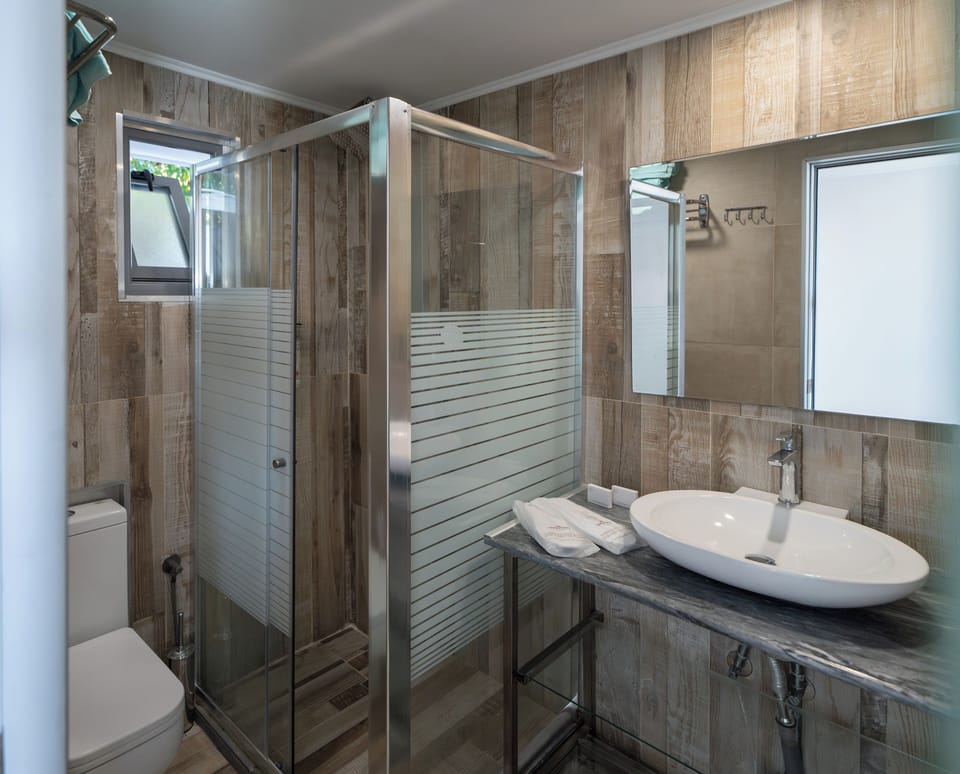 Superior Triple Room, Beach View | Bathroom | Hair dryer, towels, soap, shampoo