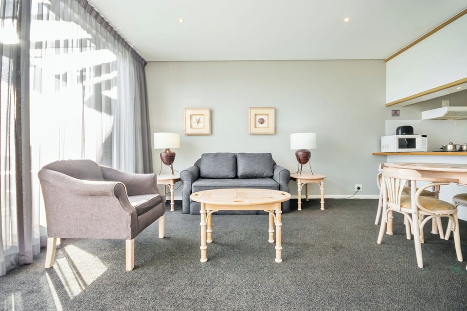 Beachfront Cabana | Living area | 82-cm LCD TV with satellite channels, TV