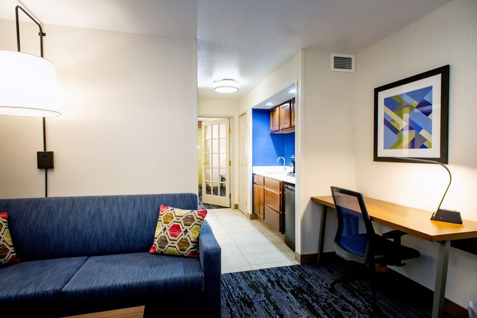 Premium bedding, desk, laptop workspace, blackout drapes