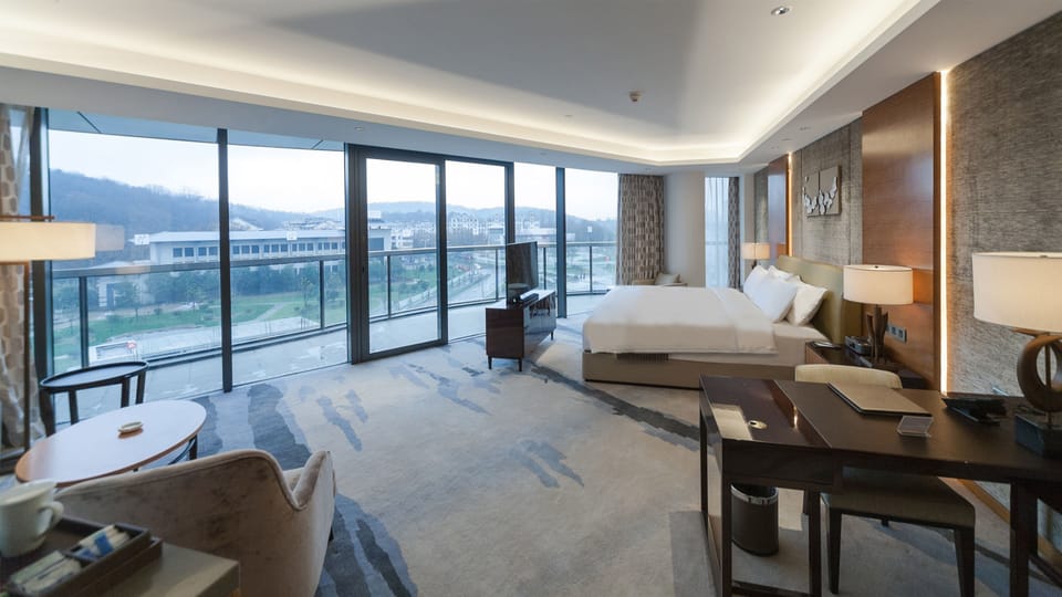 1 King Suite City View Balcony | Minibar, in-room safe, desk, blackout drapes