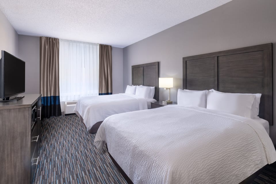 Suite, 2 Queen Beds | Desk, iron/ironing board, free cribs/infant beds, rollaway beds