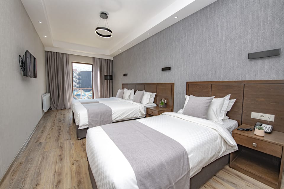 Superior Triple Room | Minibar, in-room safe, desk, iron/ironing board