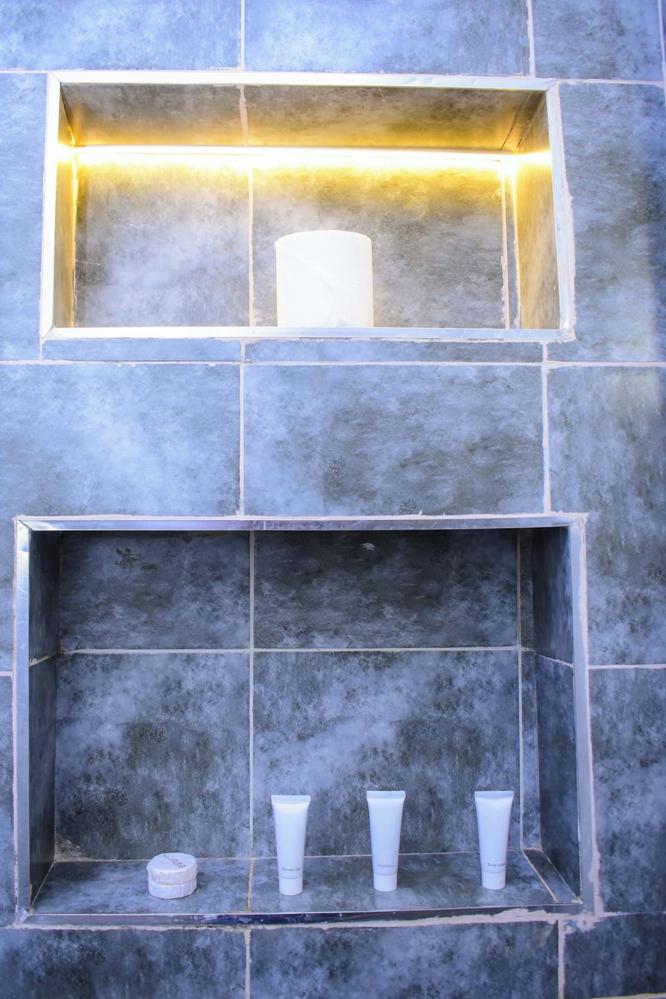 Shower, designer toiletries, slippers, towels