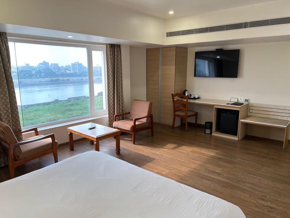 Deluxe Room, Multiple Beds | Living area | 32-inch LCD TV with satellite channels, TV