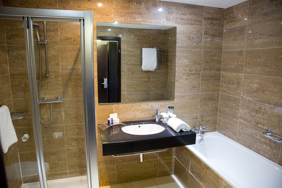 Separate tub and shower, designer toiletries, hair dryer, towels