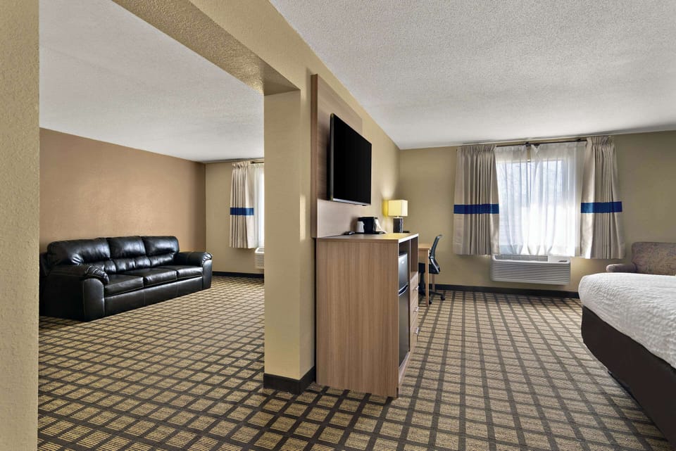 Suite, 1 King Bed, Non Smoking | Desk, laptop workspace, blackout drapes, iron/ironing board