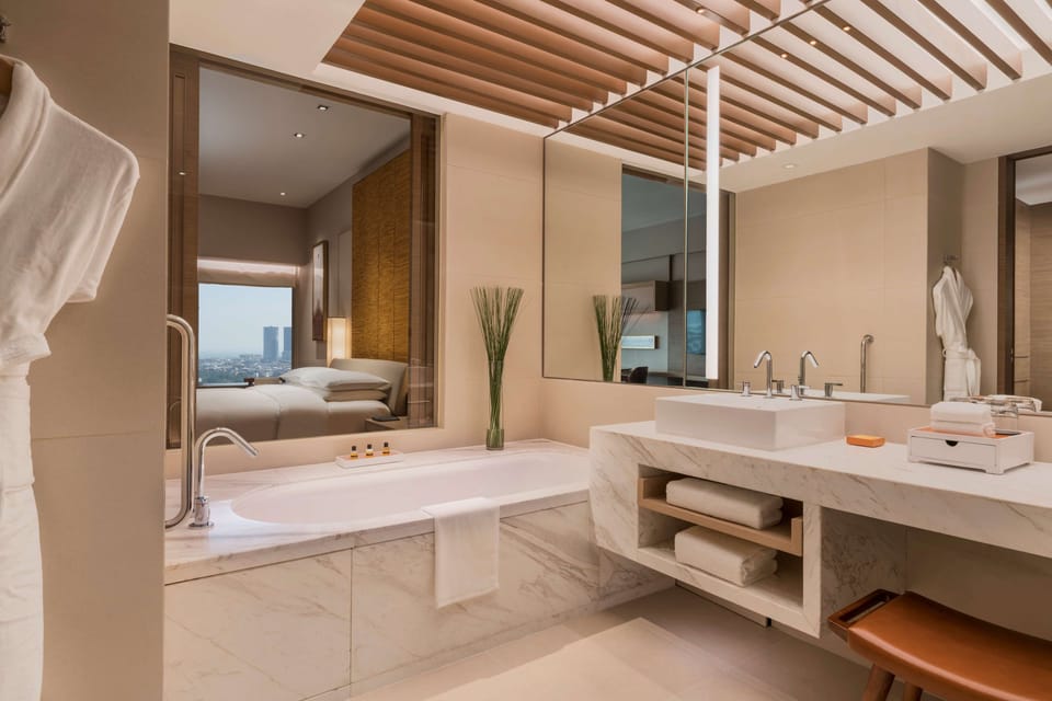 Separate tub and shower, hydromassage showerhead, designer toiletries