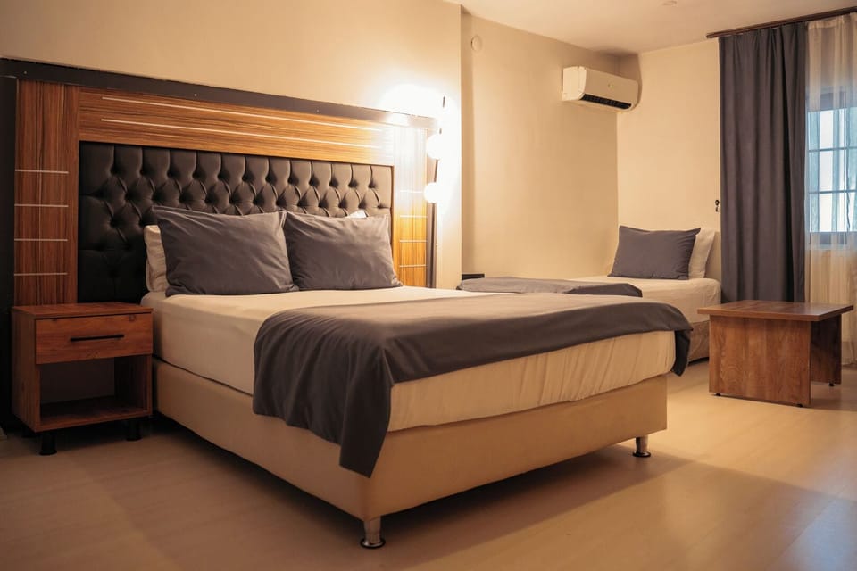 Family Quadruple Room | Minibar, desk, laptop workspace, blackout drapes