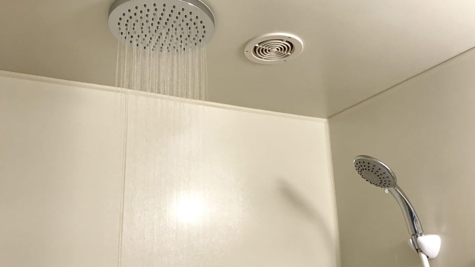 Combined shower/tub, free toiletries, hair dryer, slippers