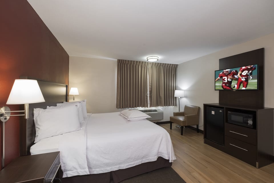 Premium Room, 1 King Bed (Upgraded Bedding & Snack, Smoke Free) | Desk, laptop workspace, blackout drapes, iron/ironing board
