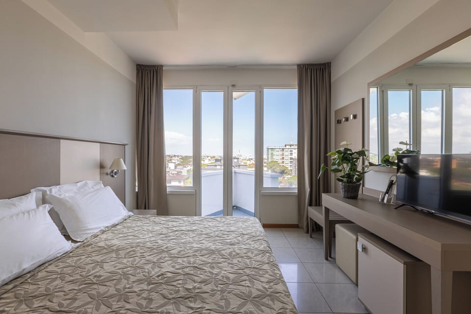 Executive Triple Room, City View | Minibar, in-room safe, desk, blackout drapes