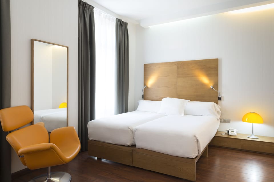Standard Double Room | Minibar, in-room safe, desk, blackout drapes