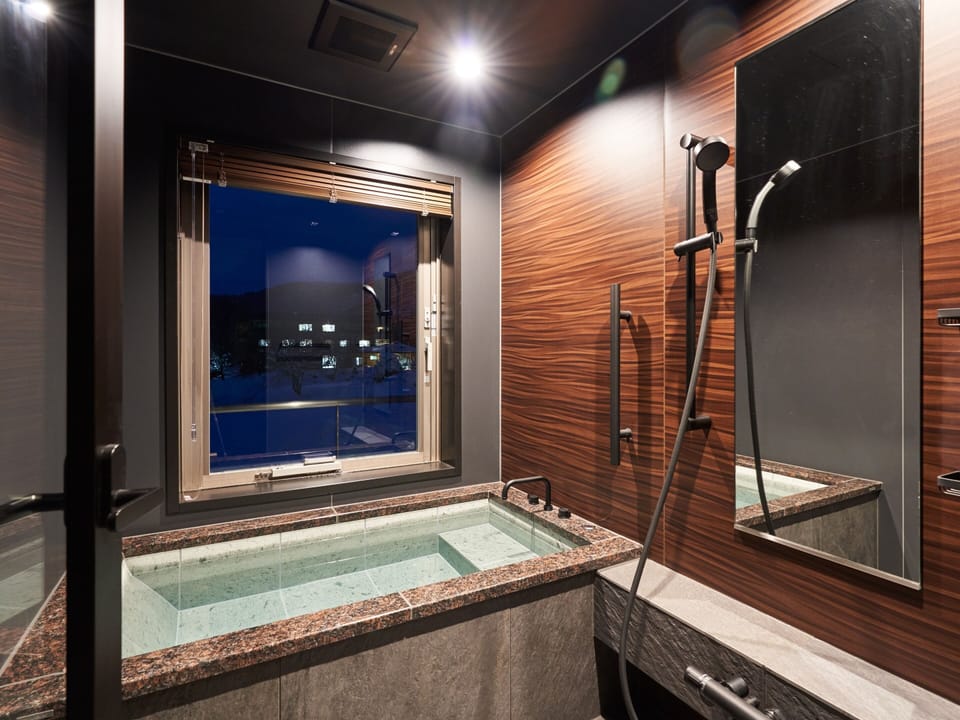 Junior Suite, Non Smoking | Bathroom | Combined shower/tub, deep soaking tub, free toiletries, slippers