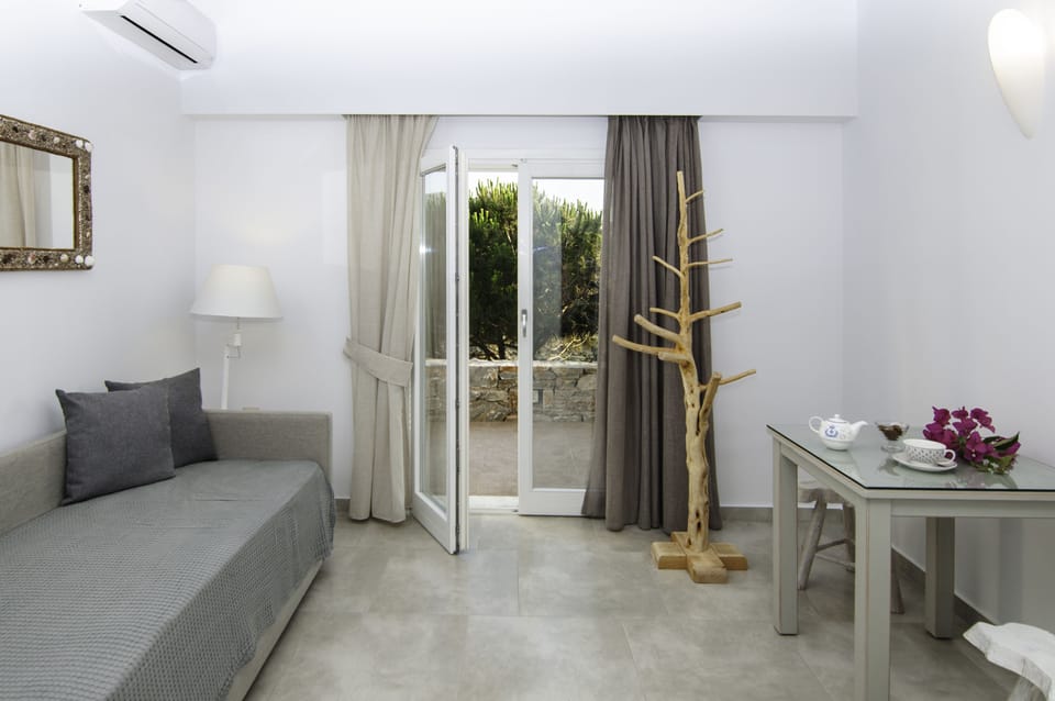 Quadruple Room, Sea View | Living area | Flat-screen TV