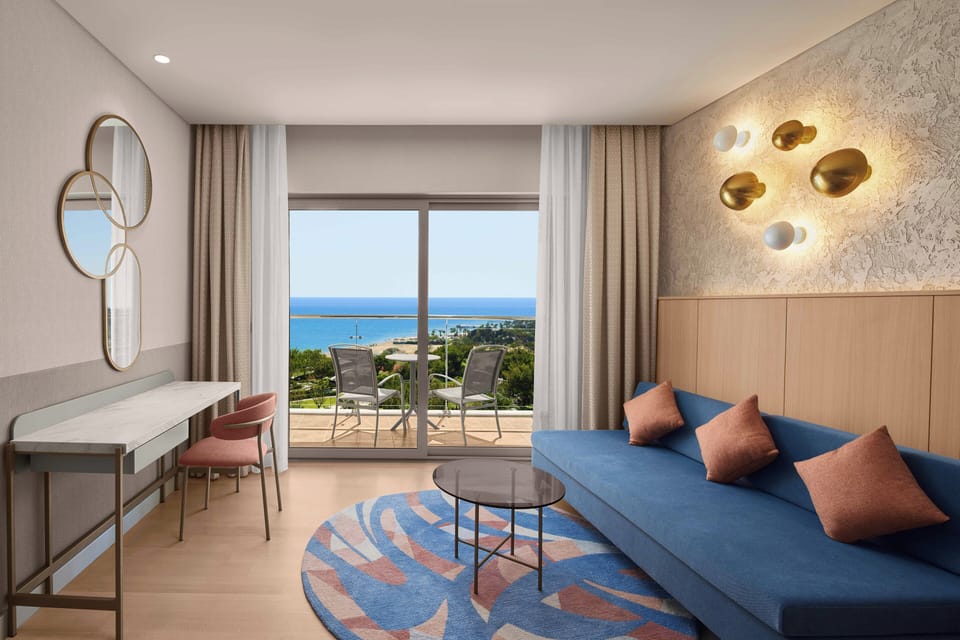 Deluxe Room, Sea View (Mixed Section) | Minibar, in-room safe, desk, iron/ironing board