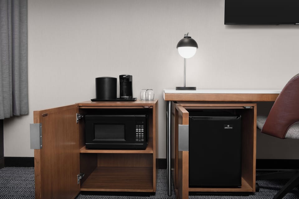 Premium bedding, desk, laptop workspace, blackout drapes