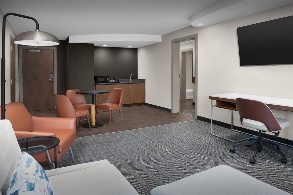 Premium bedding, desk, laptop workspace, blackout drapes