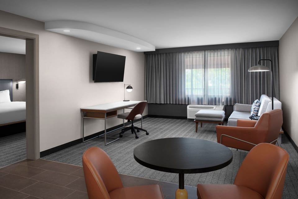 Premium bedding, desk, laptop workspace, blackout drapes