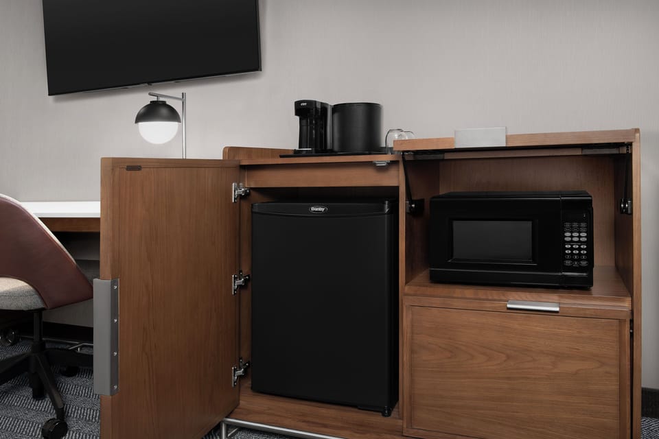 Premium bedding, desk, laptop workspace, blackout drapes