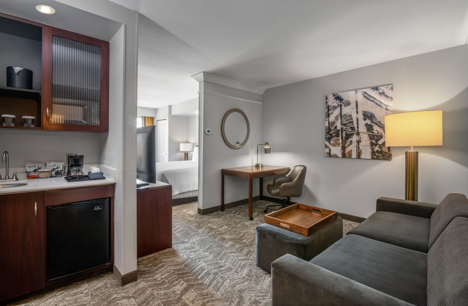 Premium bedding, desk, laptop workspace, blackout drapes