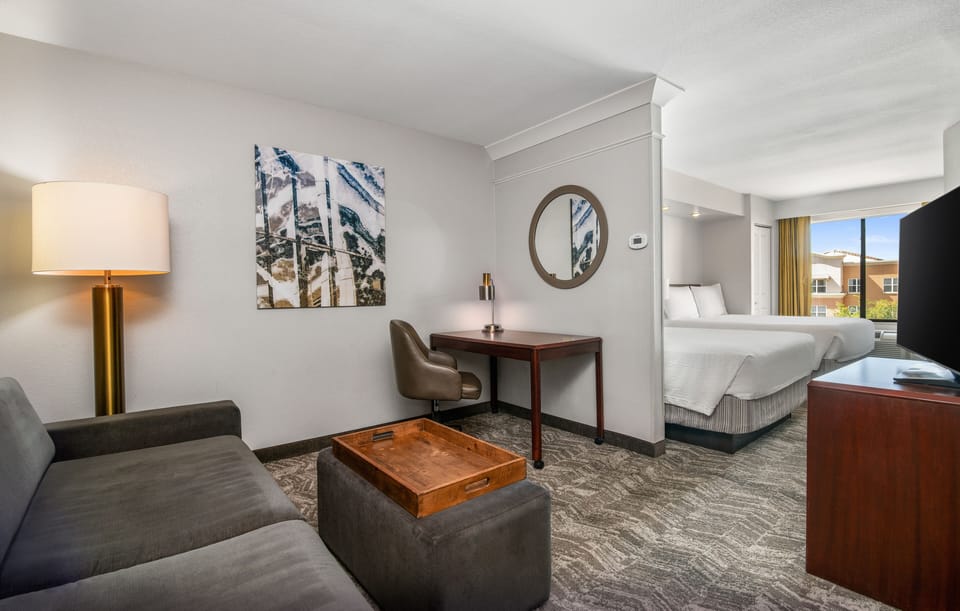 Premium bedding, desk, laptop workspace, blackout drapes