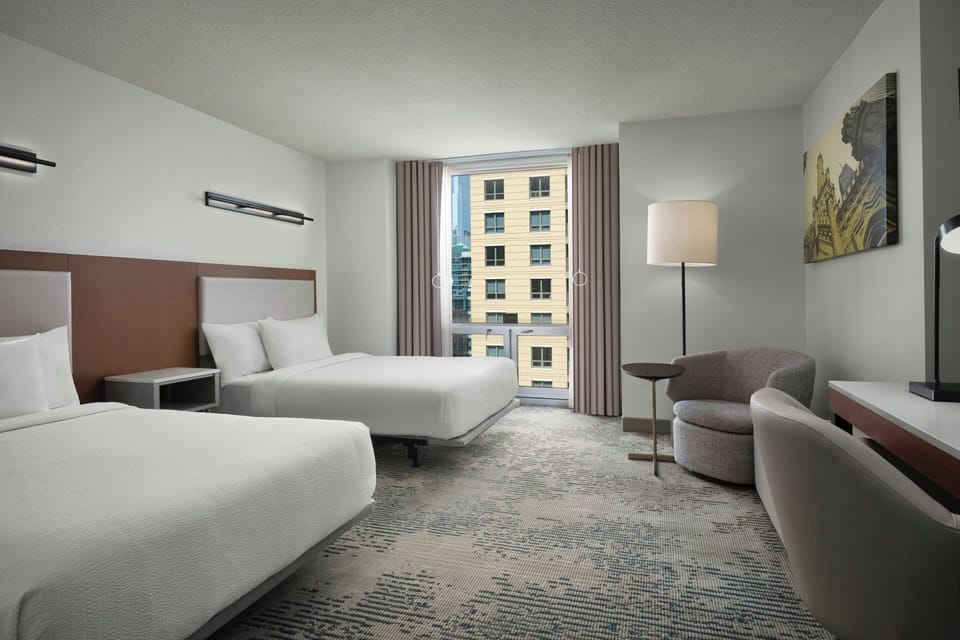 Premium bedding, desk, laptop workspace, blackout drapes
