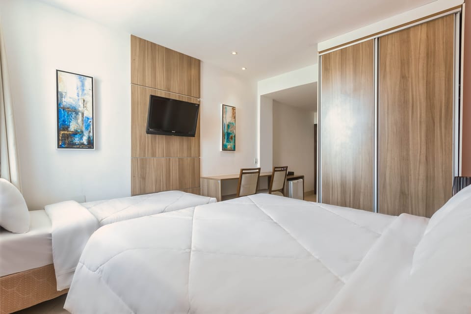 Superior Triple Room | Minibar, in-room safe, desk, blackout drapes