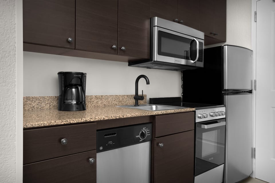 Suite, 1 Bedroom | Private kitchen | Full-size fridge, microwave, stovetop, dishwasher
