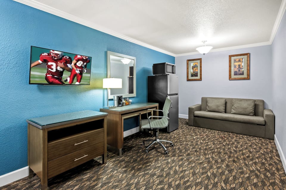 Suite, 1 King Bed, Non Smoking, Poolside | Desk, laptop workspace, blackout drapes, iron/ironing board