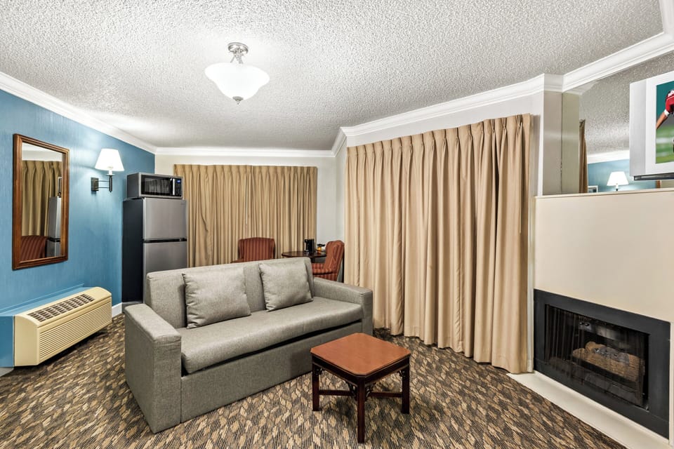 Suite, 1 King Bed, Non Smoking, Jetted Tub | Desk, laptop workspace, blackout drapes, iron/ironing board