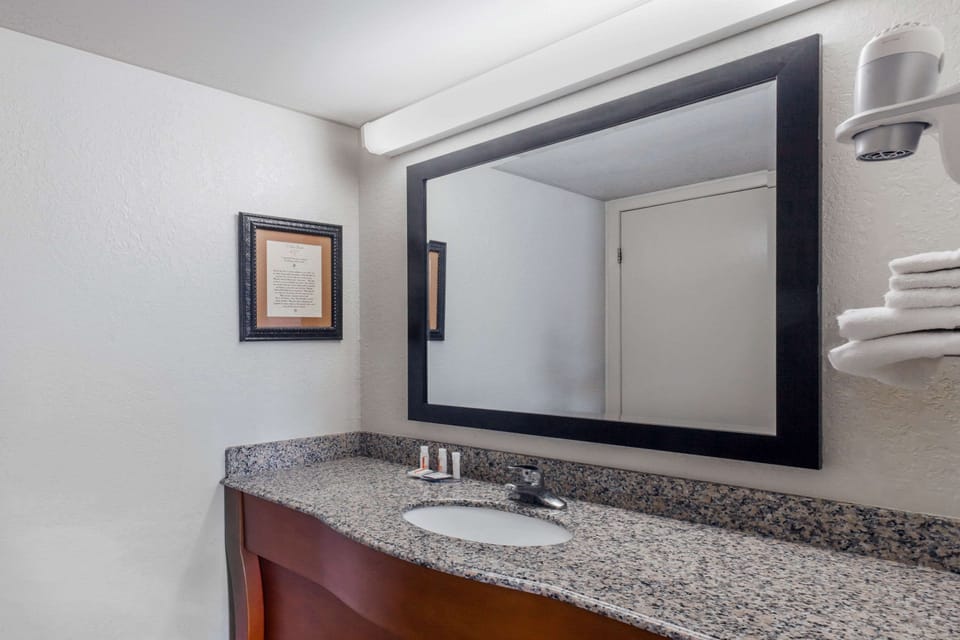 Shower, designer toiletries, hair dryer, towels