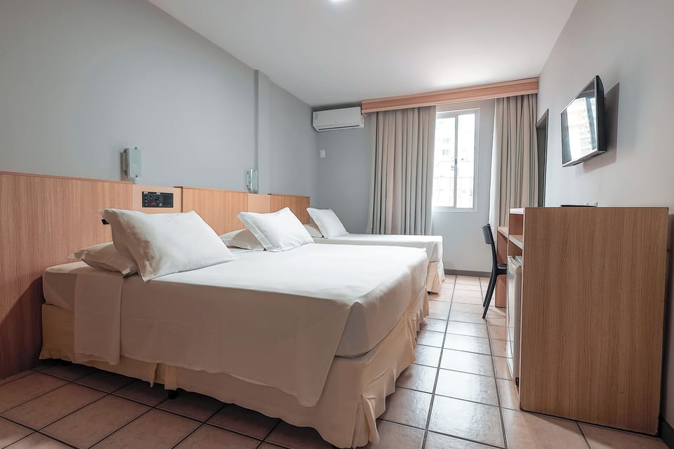 Standard Triple Room | Minibar, in-room safe, desk, blackout drapes
