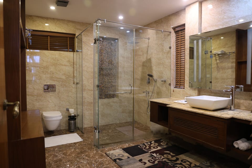 Luxury Suite, 1 King Bed | Bathroom | Shower, rainfall showerhead, free toiletries, slippers