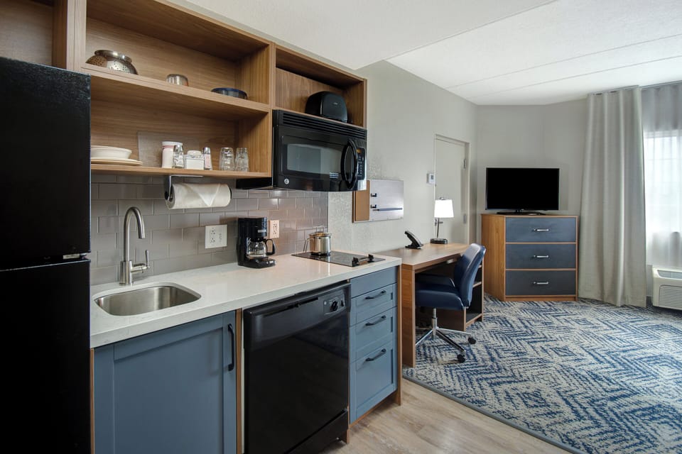 Premium bedding, desk, laptop workspace, blackout drapes