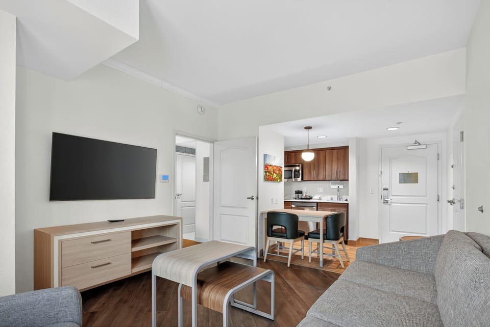 Suite, 2 Queen Beds | Living area | 32-inch LCD TV with cable channels, TV, pay movies
