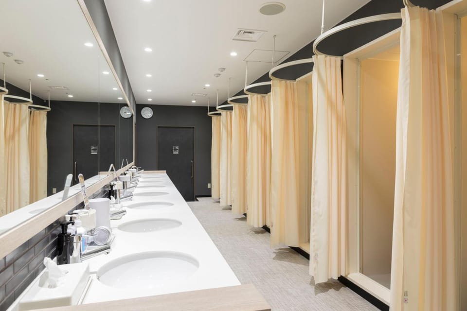Shower, hair dryer, slippers, towels