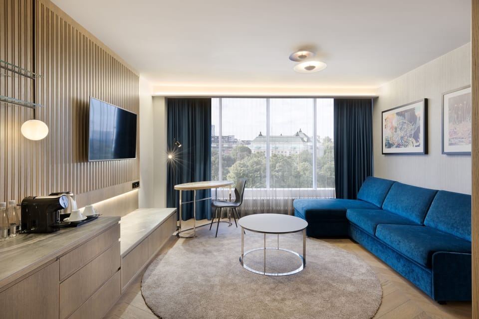 Suite, 1 King Bed, City View, Corner | Living area | 43-inch LCD TV with cable channels, TV