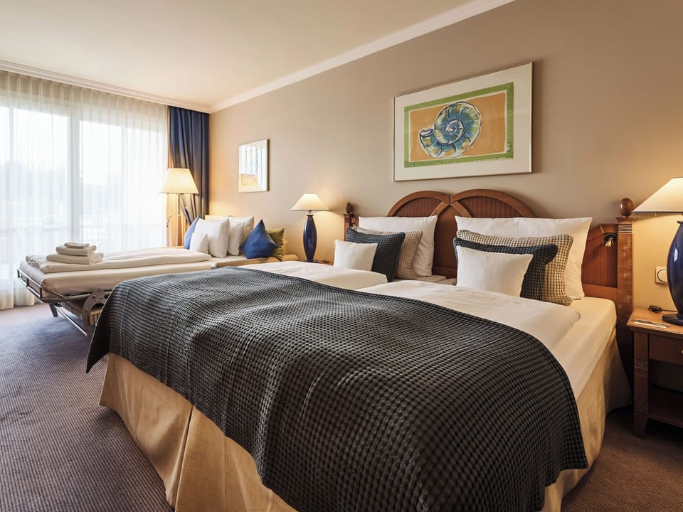 Double Room, Partial Sea View | Pillowtop beds, free minibar, in-room safe, blackout drapes