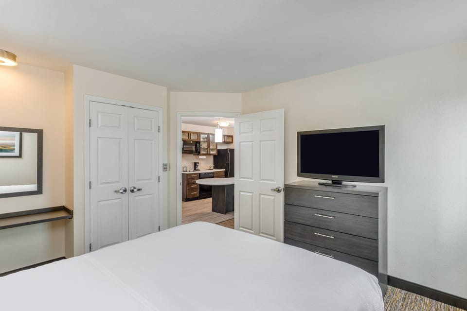 Hypo-allergenic bedding, desk, laptop workspace, blackout drapes