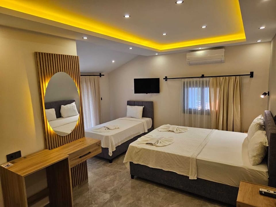 Triple Room | Minibar, desk, iron/ironing board (on request), cribs (free)