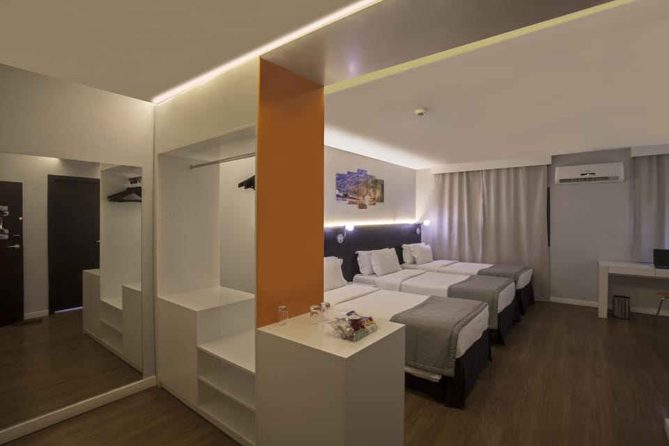 Superior Triple Room | Minibar, in-room safe, desk, blackout drapes