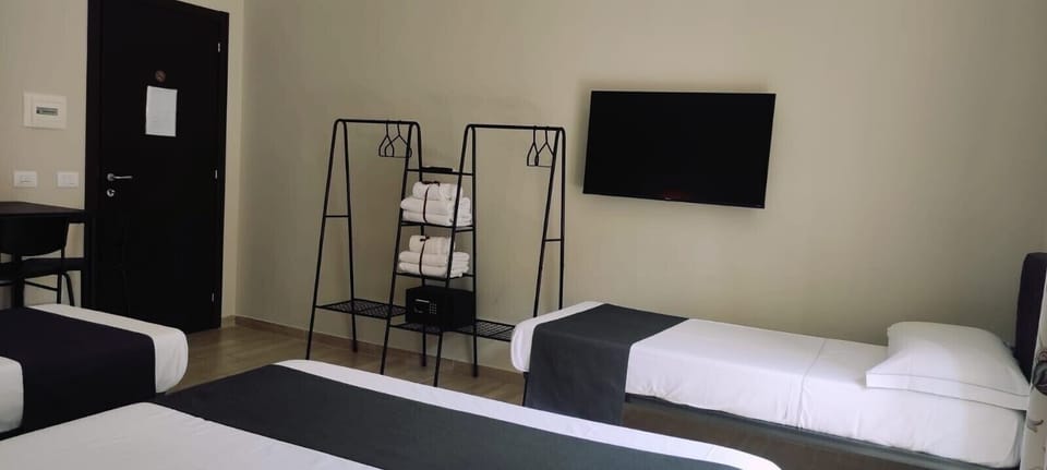 Classic Quadruple Room | Minibar, in-room safe, desk, blackout drapes