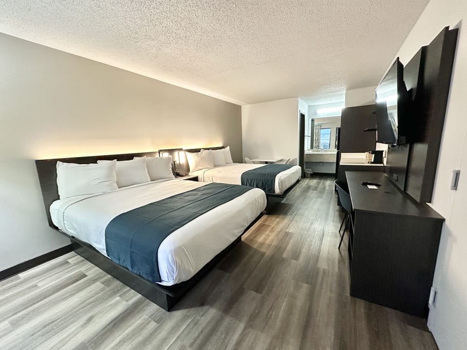 Desk, laptop workspace, blackout drapes, bed sheets