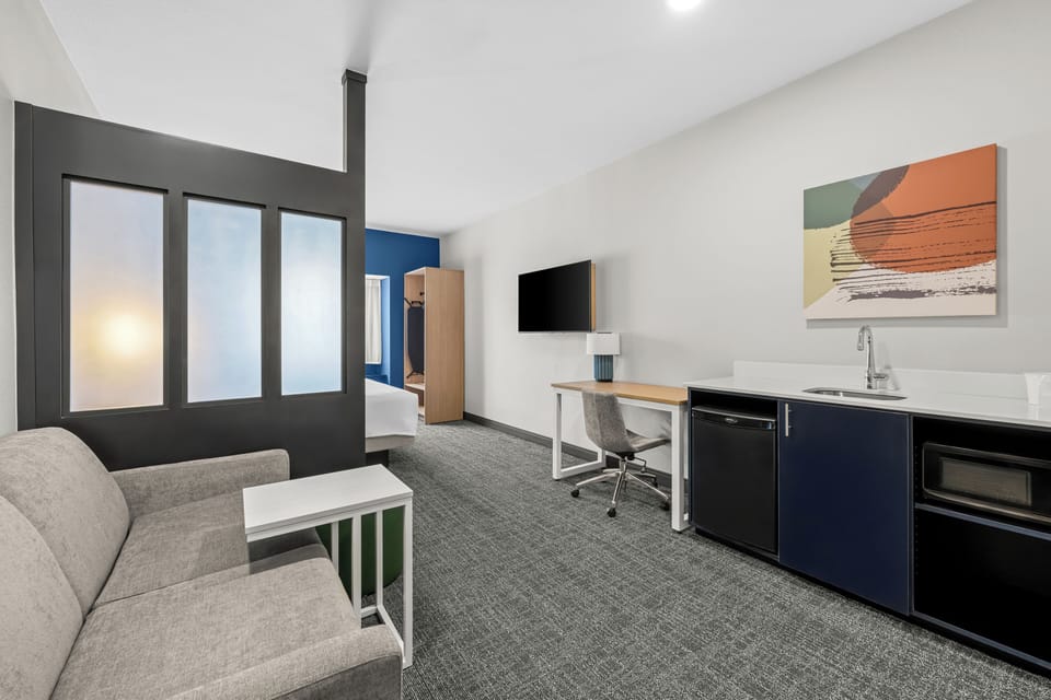 Desk, laptop workspace, blackout drapes, iron/ironing board