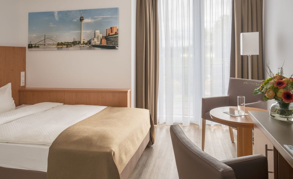 Hypo-allergenic bedding, desk, laptop workspace, blackout drapes