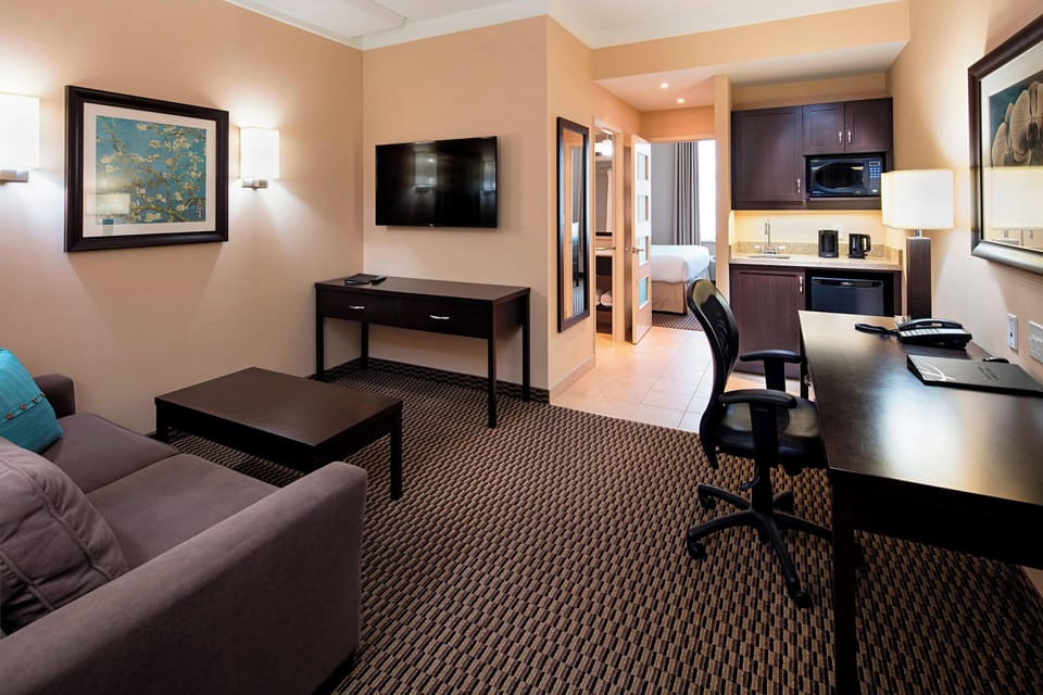Premium bedding, desk, laptop workspace, blackout drapes